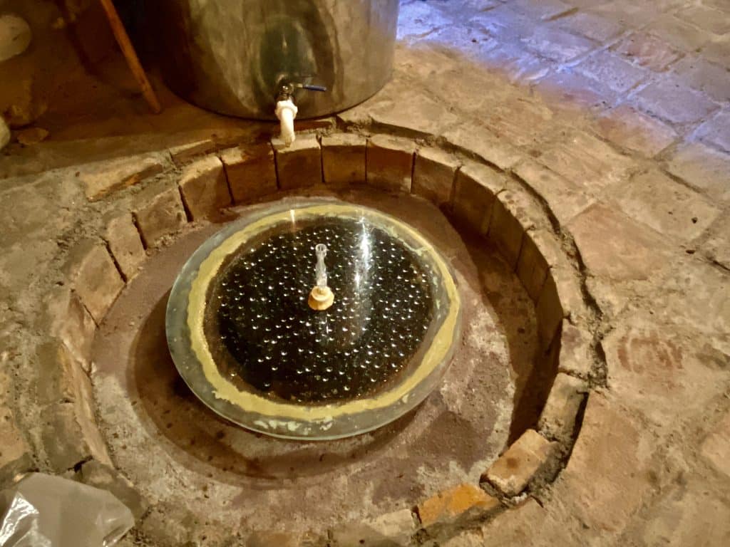 The mouth of the qvervri with the lid before it is sealed when making Georgian wine.