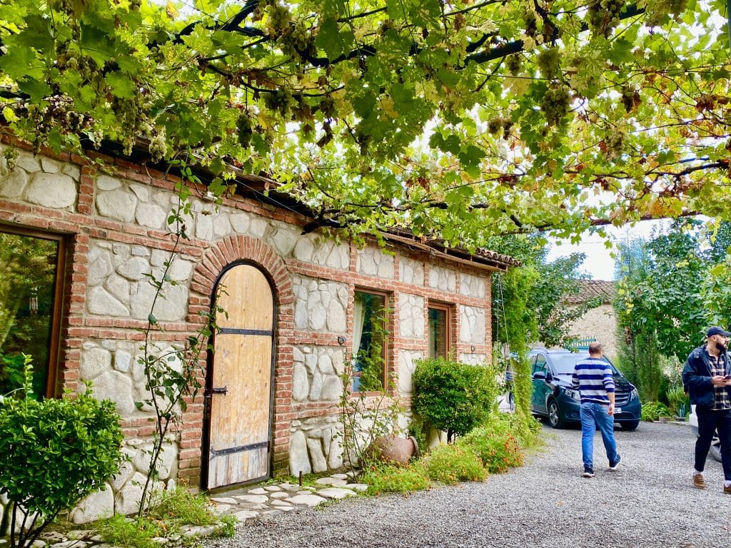 A Georgian house displaying the distinct architectural style of the region with the natural stone beauty accented with red bricks