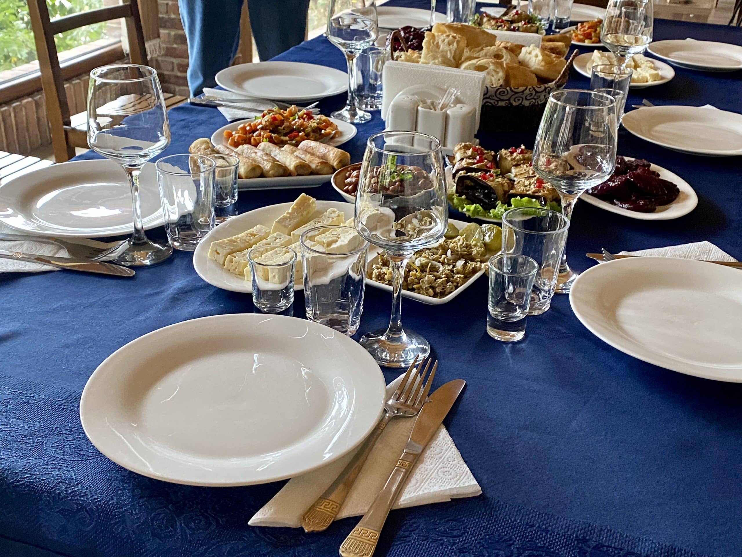 A table filled with foods, wine glasses, and plates