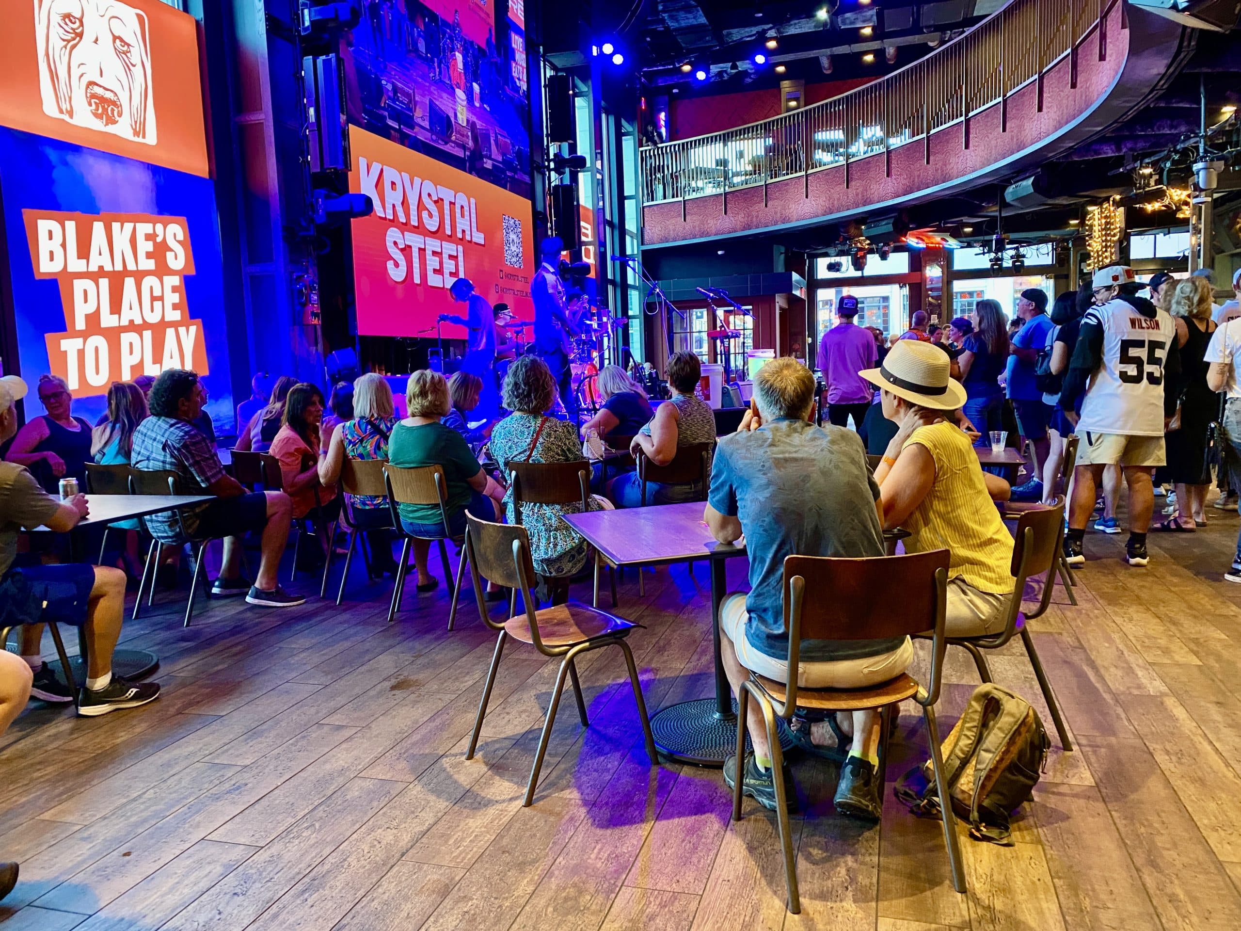 A picture of a stage in Ole Red with patrons watching